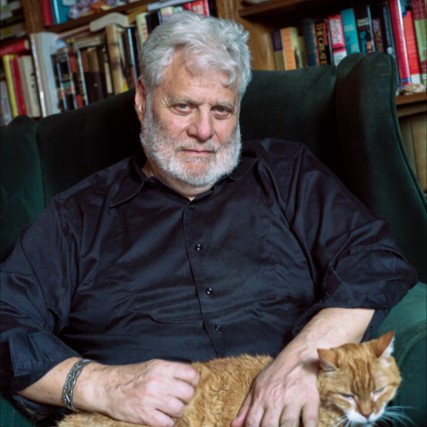 Mark Kurlansky sitting with an orange cat